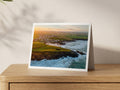 Premium A5 greeting card showing Round Hole blowhole at Trevone in warm sunrise light