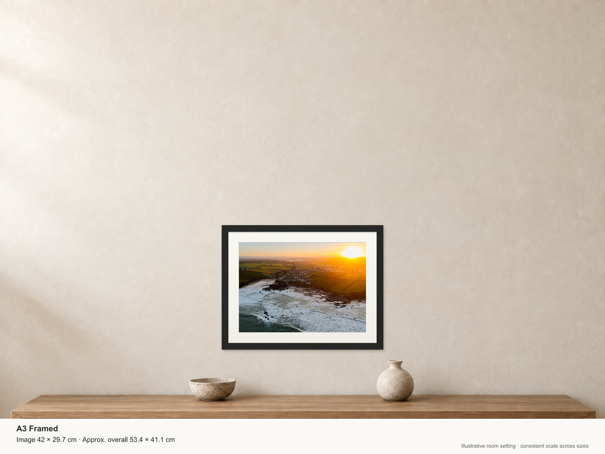 Golden Sunrise Over Trevone Bay — A3 framed, 22mm black stained frame and 35mm mount. Illustrative room view and dimensions.