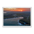 Treyarnon fridge magnet showing swirling orange sunrise cloud over Treyarnon Bay with calm sea and smooth lines of swell