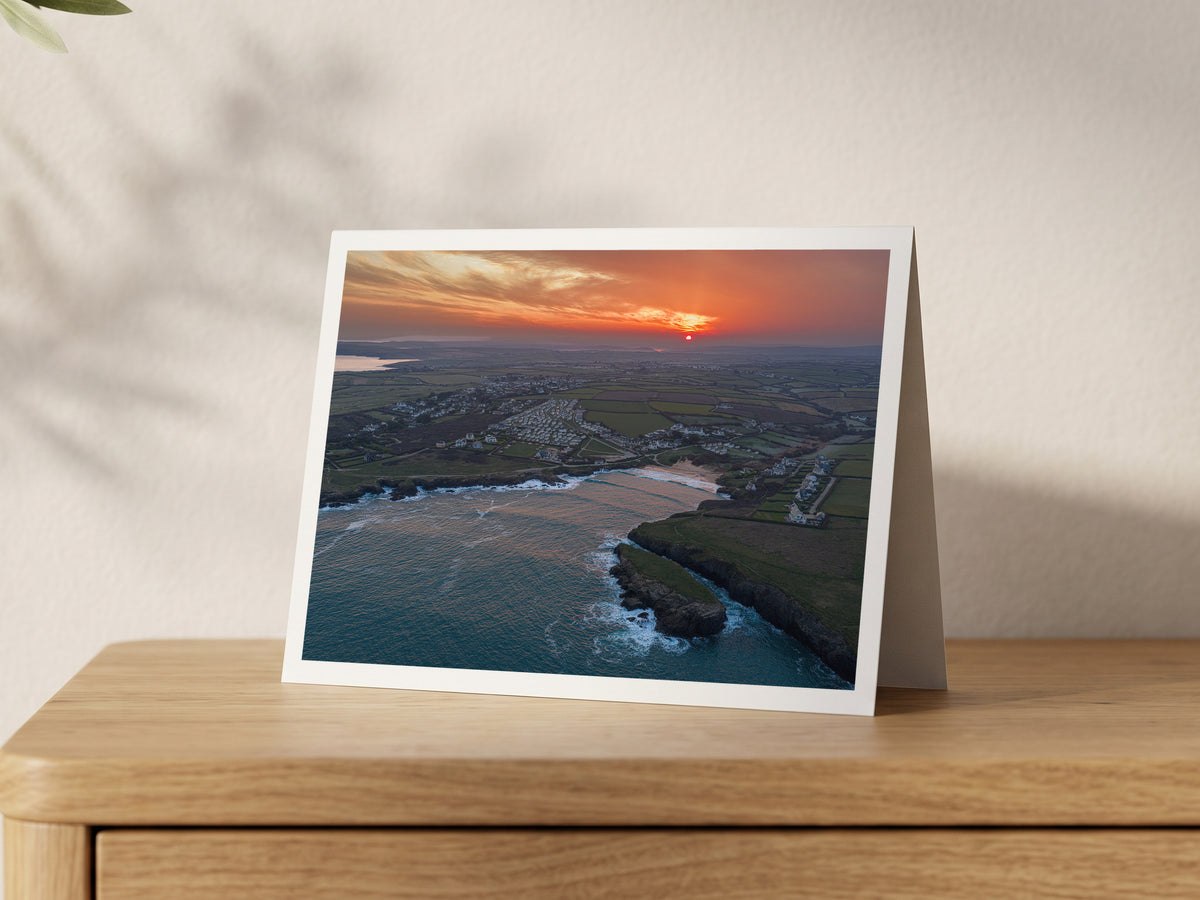 Premium A5 greeting card showing an orange sunrise over Treyarnon Bay and calm sea