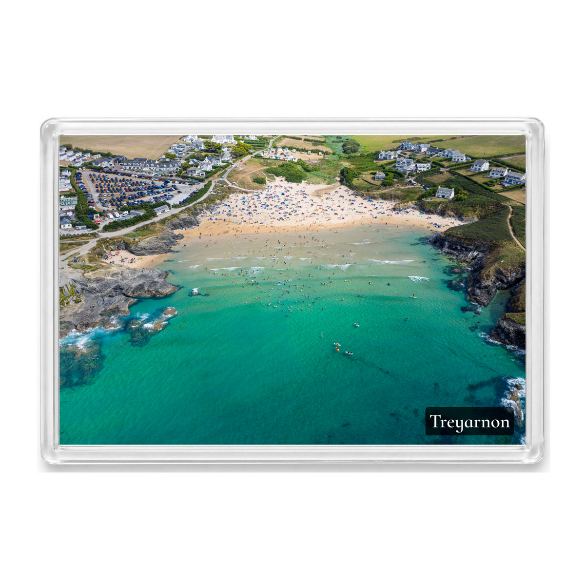 Treyarnon fridge magnet showing turquoise water, swimmers and paddleboarders, the sandy beach, low cliffs and village