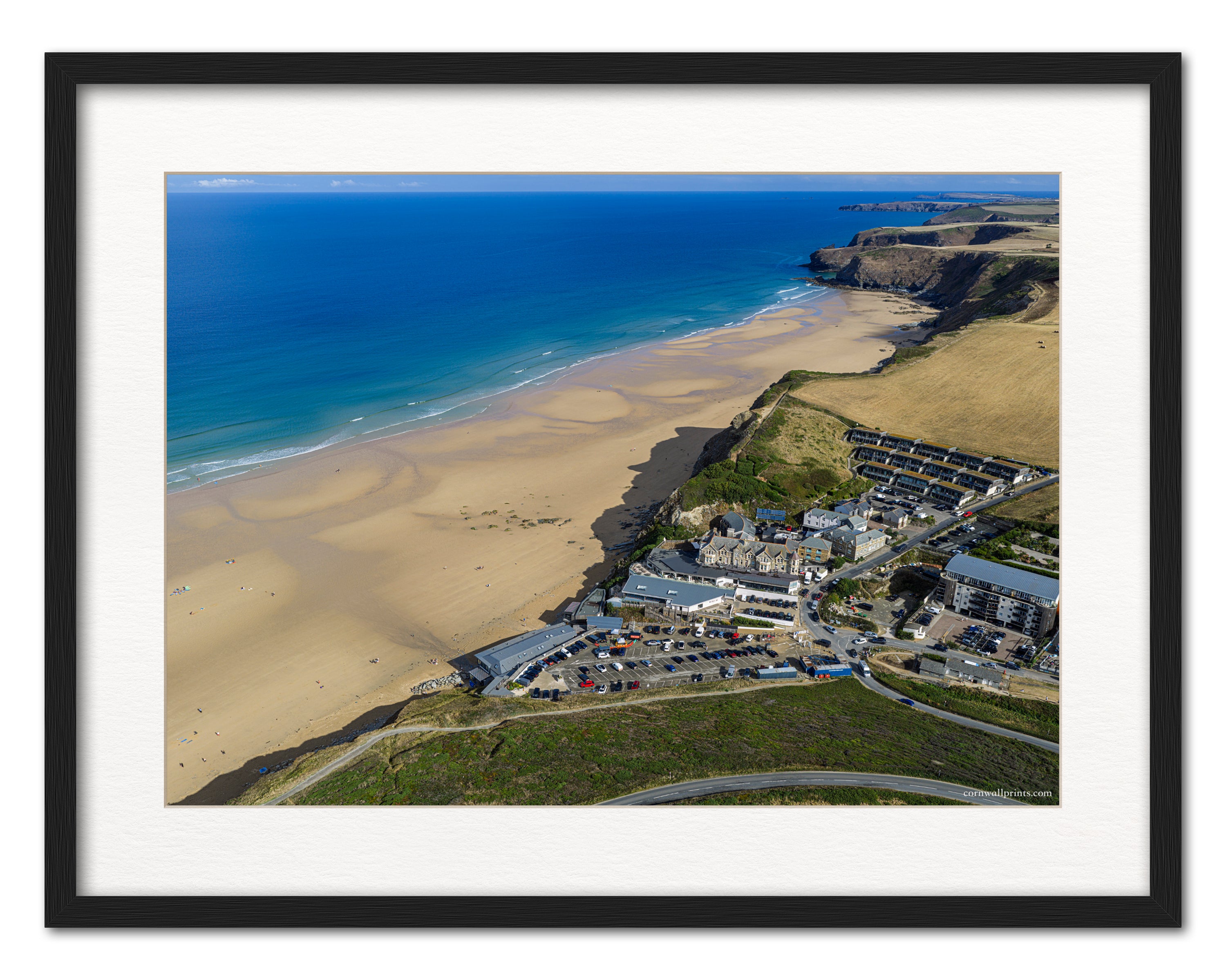 Watergate Bay beachfront aerial photograph displayed in a black frame with white mount