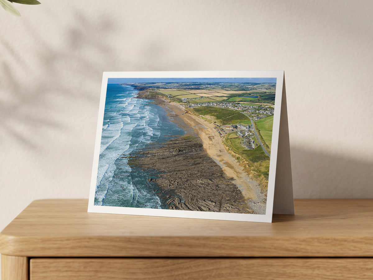Premium A5 greeting card showing Widemouth Bay surf and rock shelves looking north to Bude