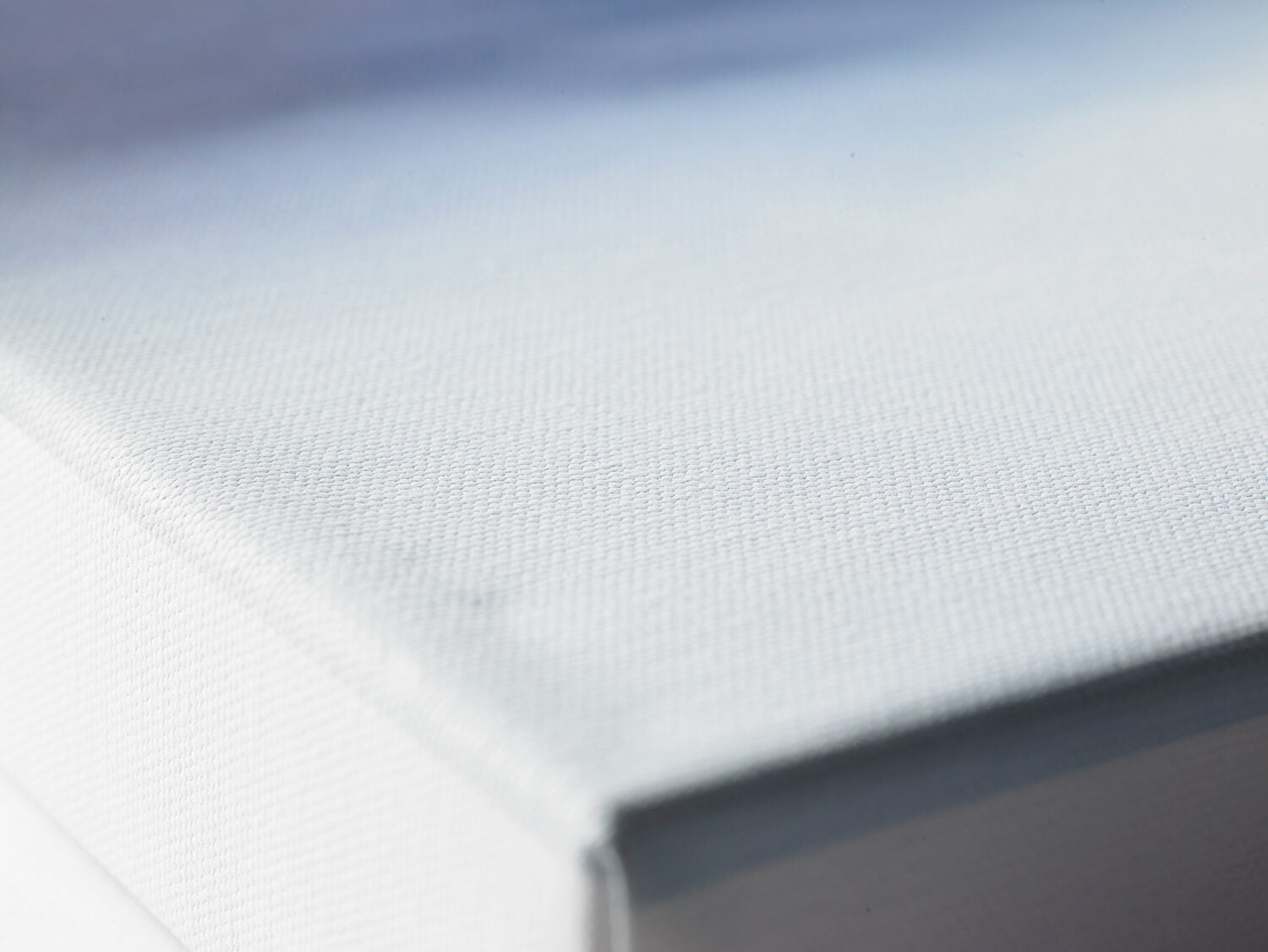 Close-up of the textured canvas surface and the edge of a 38mm-deep stretched canvas