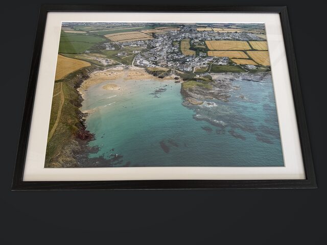 Trevone Bay print in a black wood frame with an off-white mount
