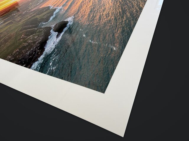 Close-up of a Porthcothan sunrise print showing the white border and glossy Signature Photo paper